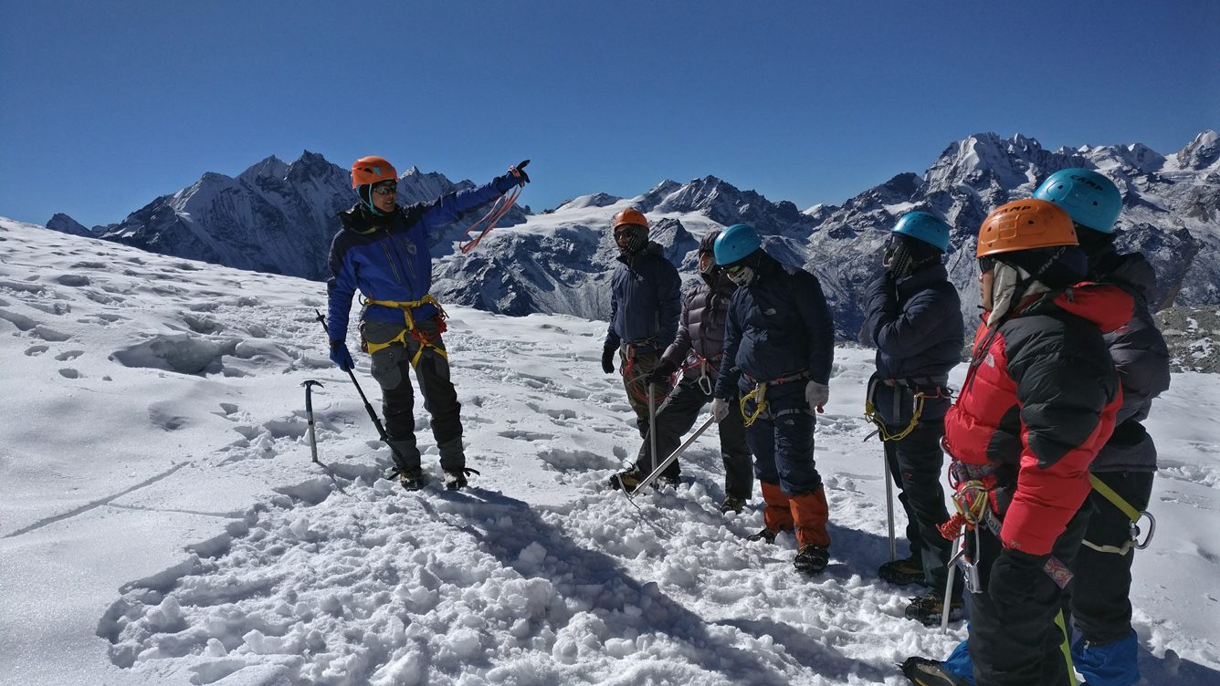 guiding a group of young researchers in fieldwork techniques on Yala Glacier